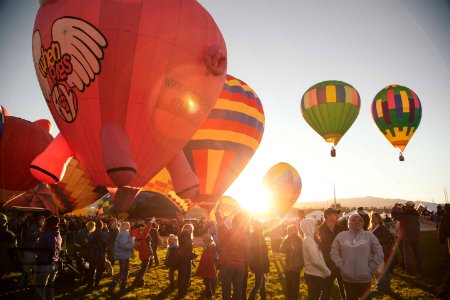 people near assorted-color hot air balloon during sunset photo