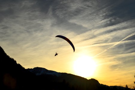 silhouette of person parachuting during sunrise photo
