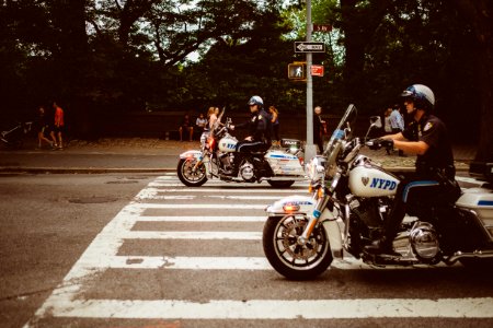 two policemen riding motorcycles on road photo
