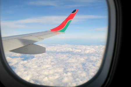 white, pink, and green airplane window viewed from a window photo