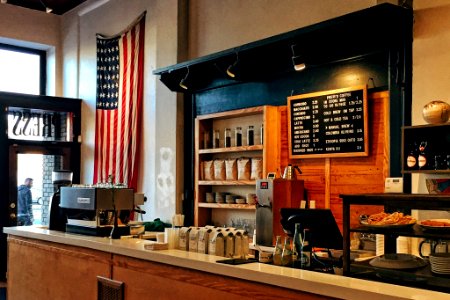 flag of U.S. America hanging on white painted concrete wall