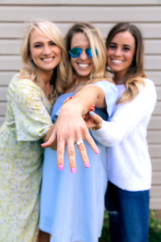 two women holding woman's hand in the middle