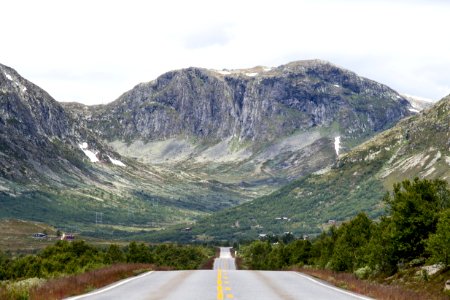 gray concrete road near mountain