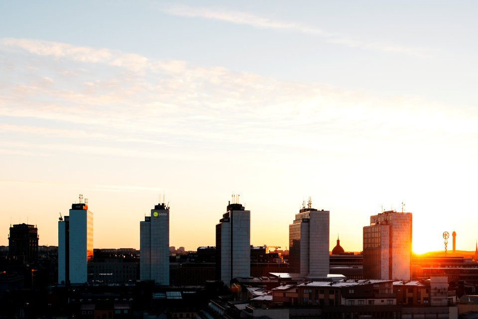 five white high-rise buildings under gray sky
