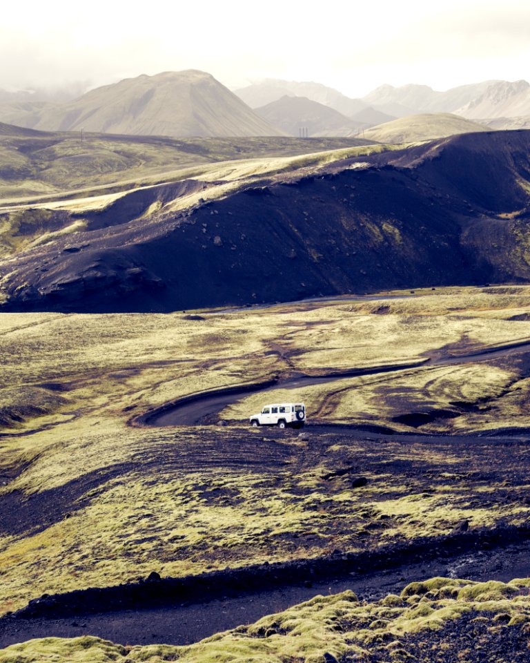 white SUV travelling on road during daytime