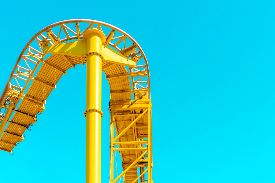 yellow roller coaster rail under clear sky