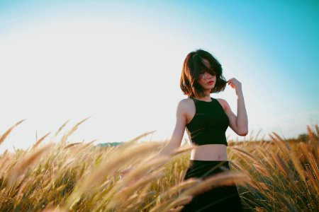 woman on wheat field during daytime photo