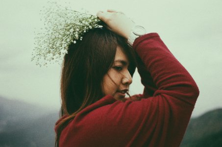 shallow focus photography of woman holding flower bouquet photo