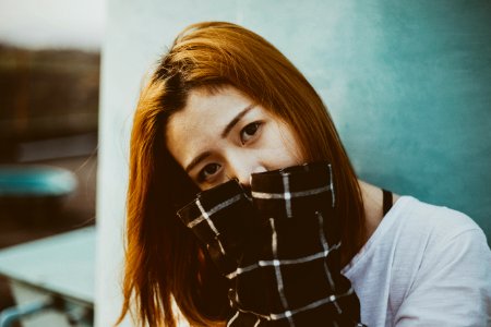 woman hiding her mouth with her hands photo