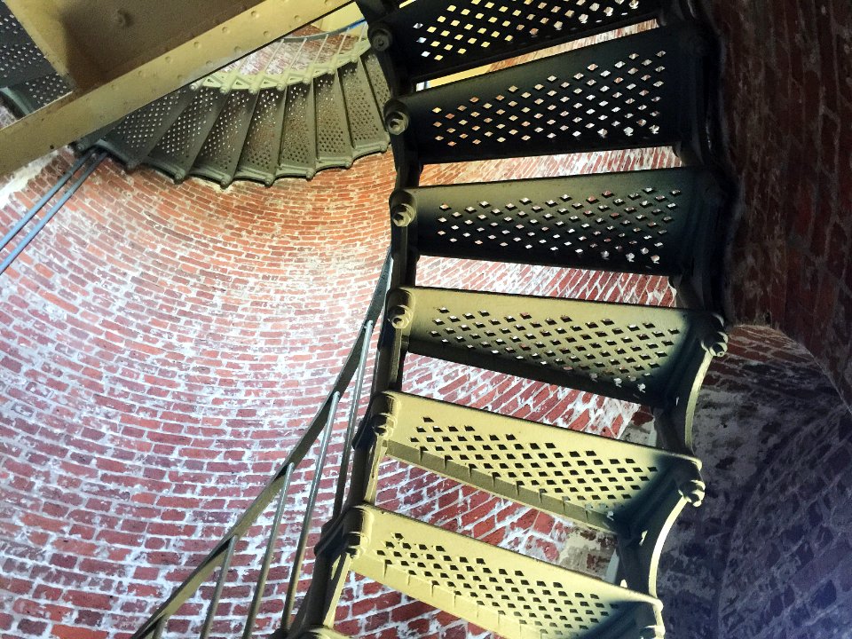 brown wooden spiral staircase with black metal railings photo