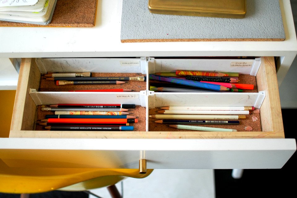 colored pencils in white wooden drawer
