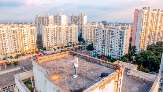 man standing on top of building photo