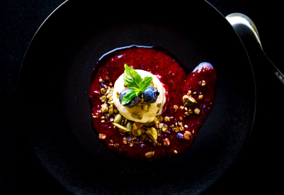 pastry with blueberry topping and sauce on plate