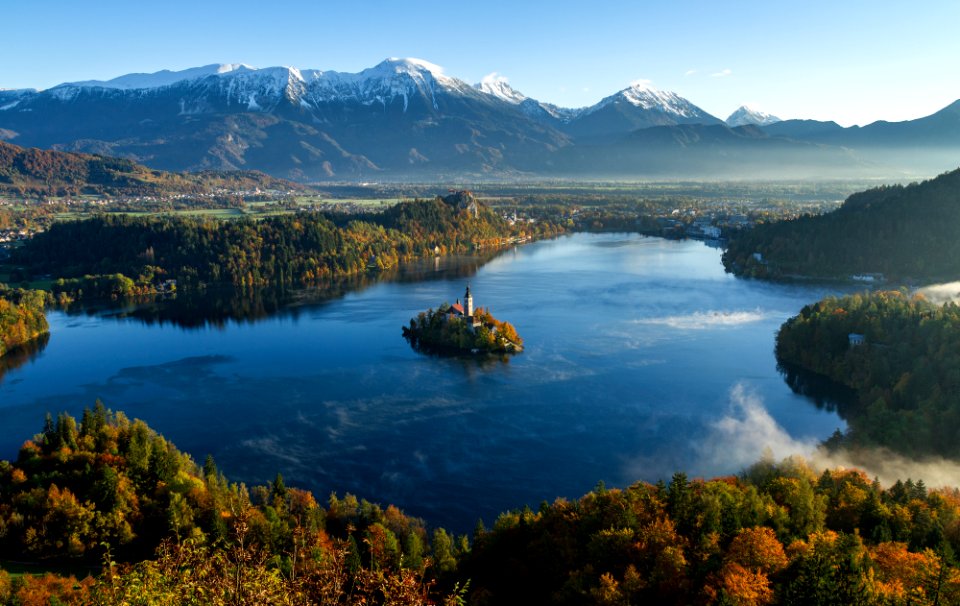 island surrounded by water and mountains at daytime