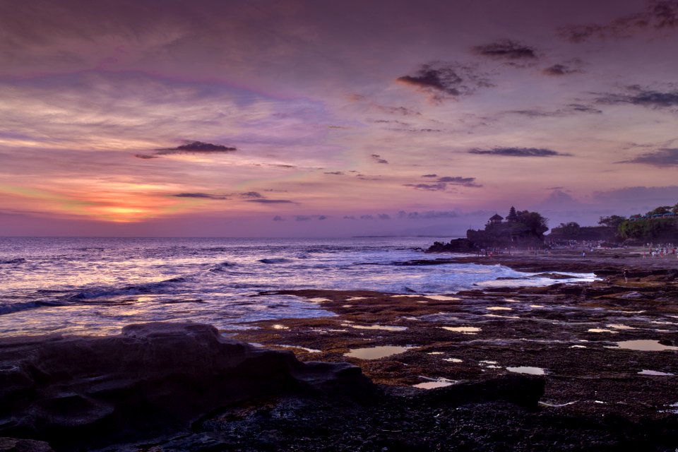 blue sea hitting seashore during golden hour