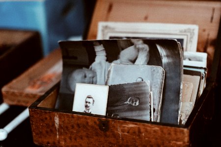 old photos in brown wooden chest photo