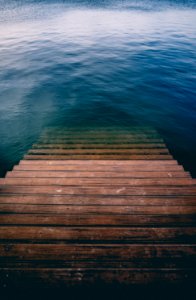 brown wooden stair on calm body of water photo