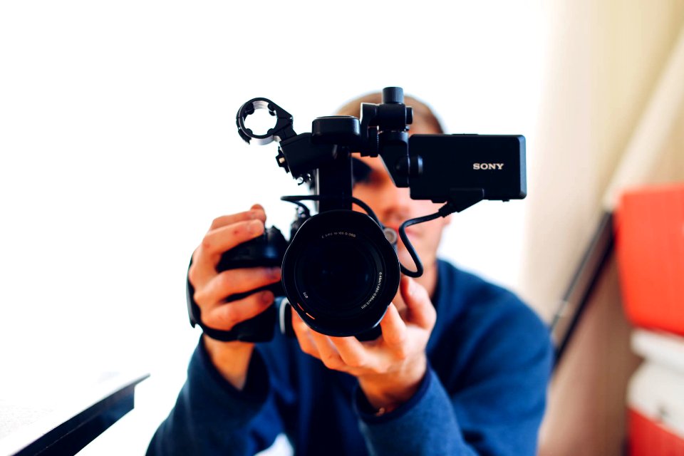 person holding DSLR camera