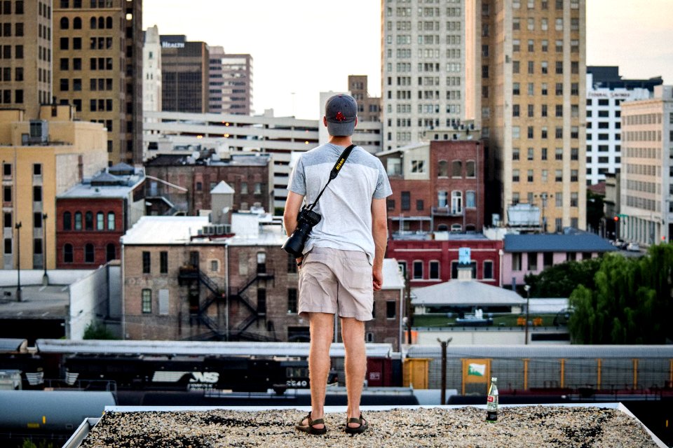 man standing on top of building at daytime photo