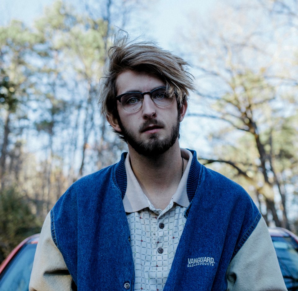 man standing against car