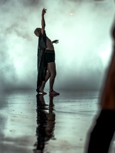 person wearing robes pointing upward