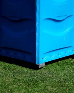 blue metal storage box on green grass