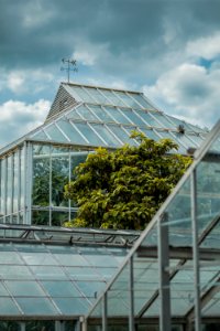 glass greenhouse under cloudy sky photo