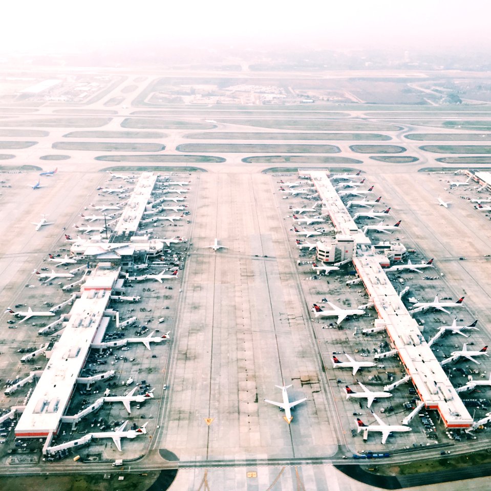 aerial view of airport with lots of airplanes during daytime