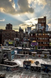 photo of gray concrete rooftop beside brown building photo