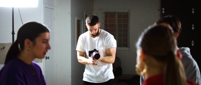 person taking photo of people during daytime photo