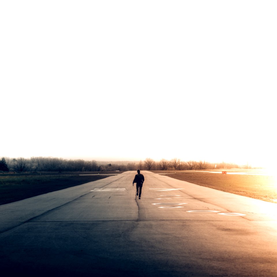 man walking on road