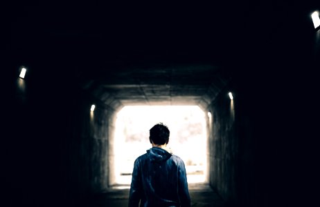 man standing in subway photo