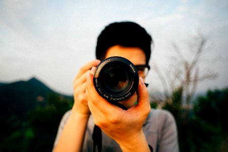 man using DSLR camera photo