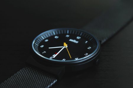 round black Braun analog watch with black band at 7:30 photo