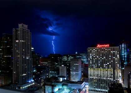 lightning bolt near skyscrapers photo