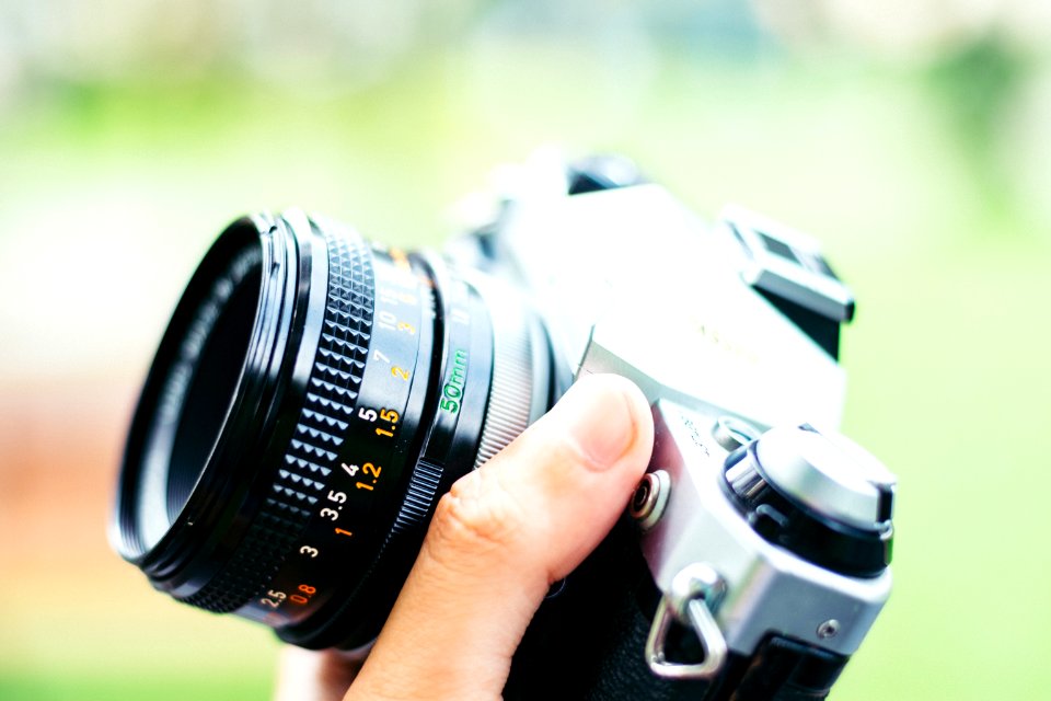 person holding black DSLR camera
