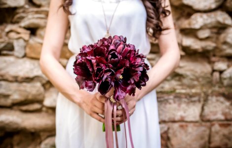 woman holding purple flower bouquet