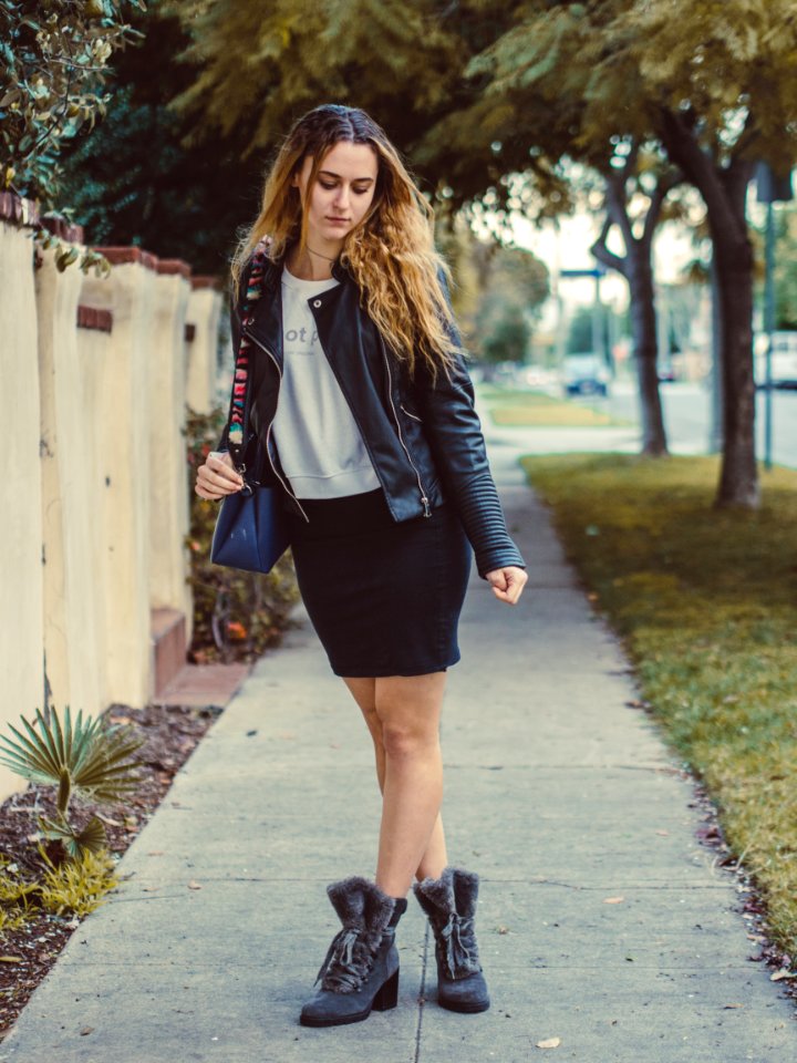 women's white crew-neck shirt and black leather jacket