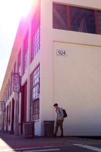 man walking beside building