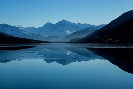 mountain near on body of water photo photo