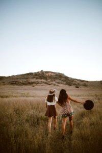 two women walking around near mountain at daytime photo