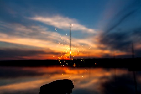 silhouette of person holding sparker photo