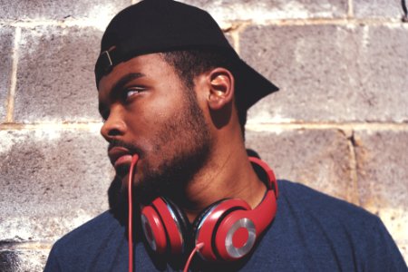 man in blue shirt with red corded headphones photo