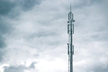 gray radio tower under the cloudy sky during daytime photo