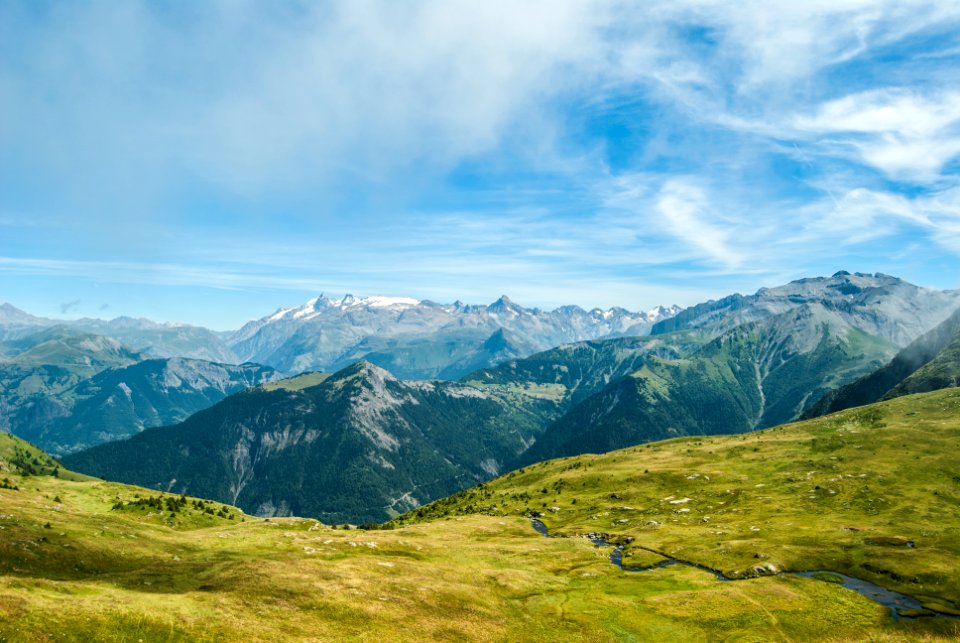 green grass field in the mountain photo