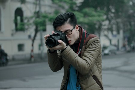 shallow focus photography of man taking photograph holding his camera photo
