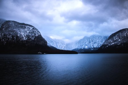 landscape photography of mountains near body of water under cloudy sky photo