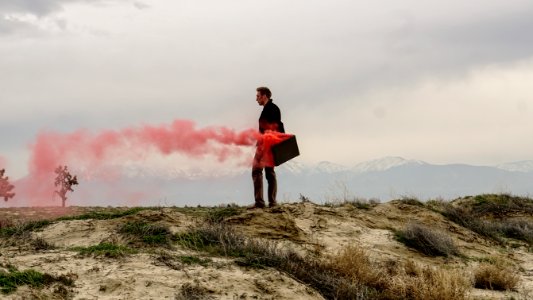 Red smoke coming out of a man's briefcase. photo