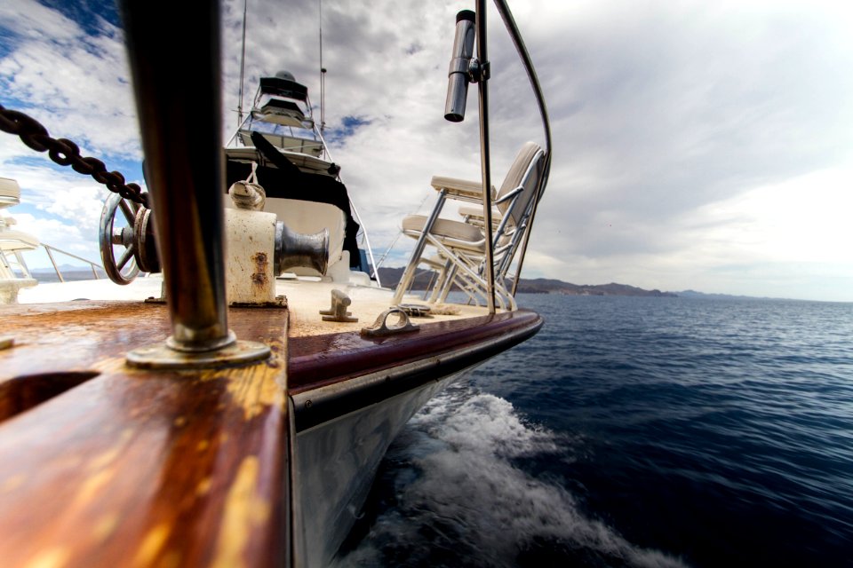 brown and white yacht on body of water