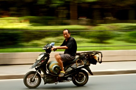photo of man wearing black shirt riding motorcycle